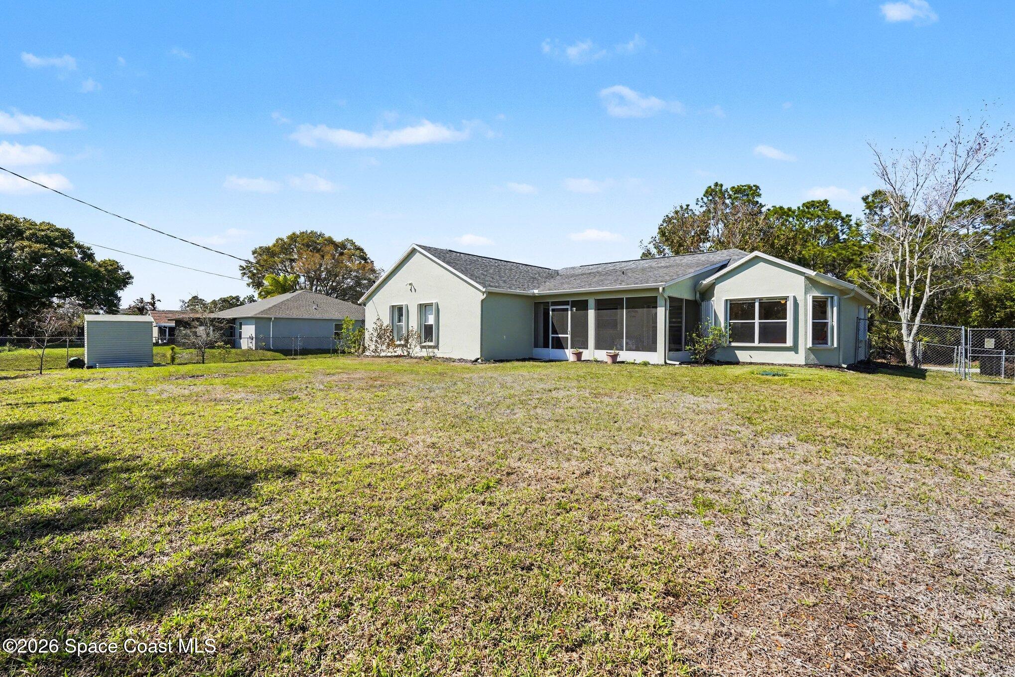 938 Commerce Road Southeast Palm Bay, FL 32909 - Photo 27 of 31 a front view of a house with a yard