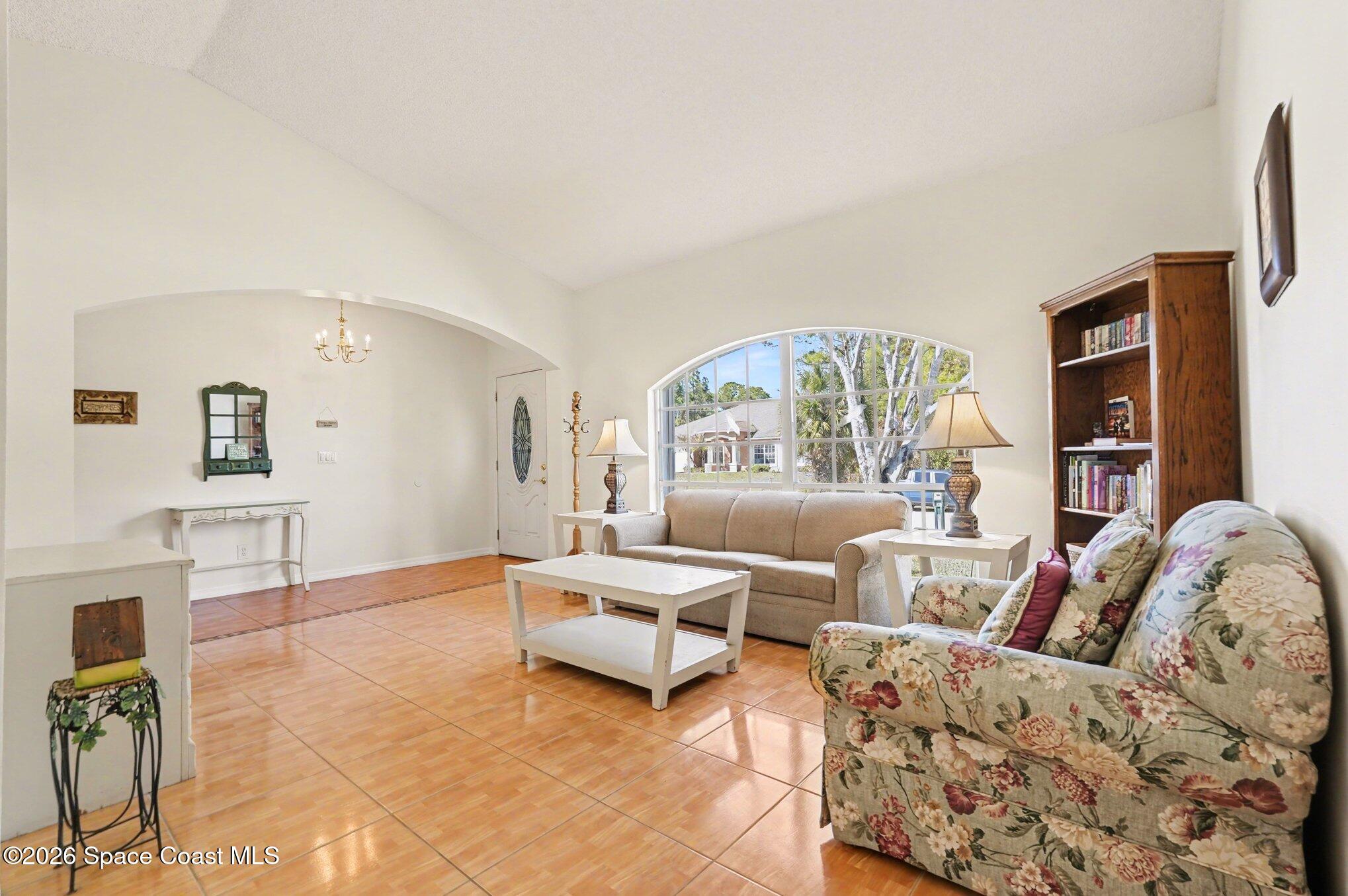 938 Commerce Road Southeast Palm Bay, FL 32909 - Photo 3 of 31 a living room with furniture and a large window