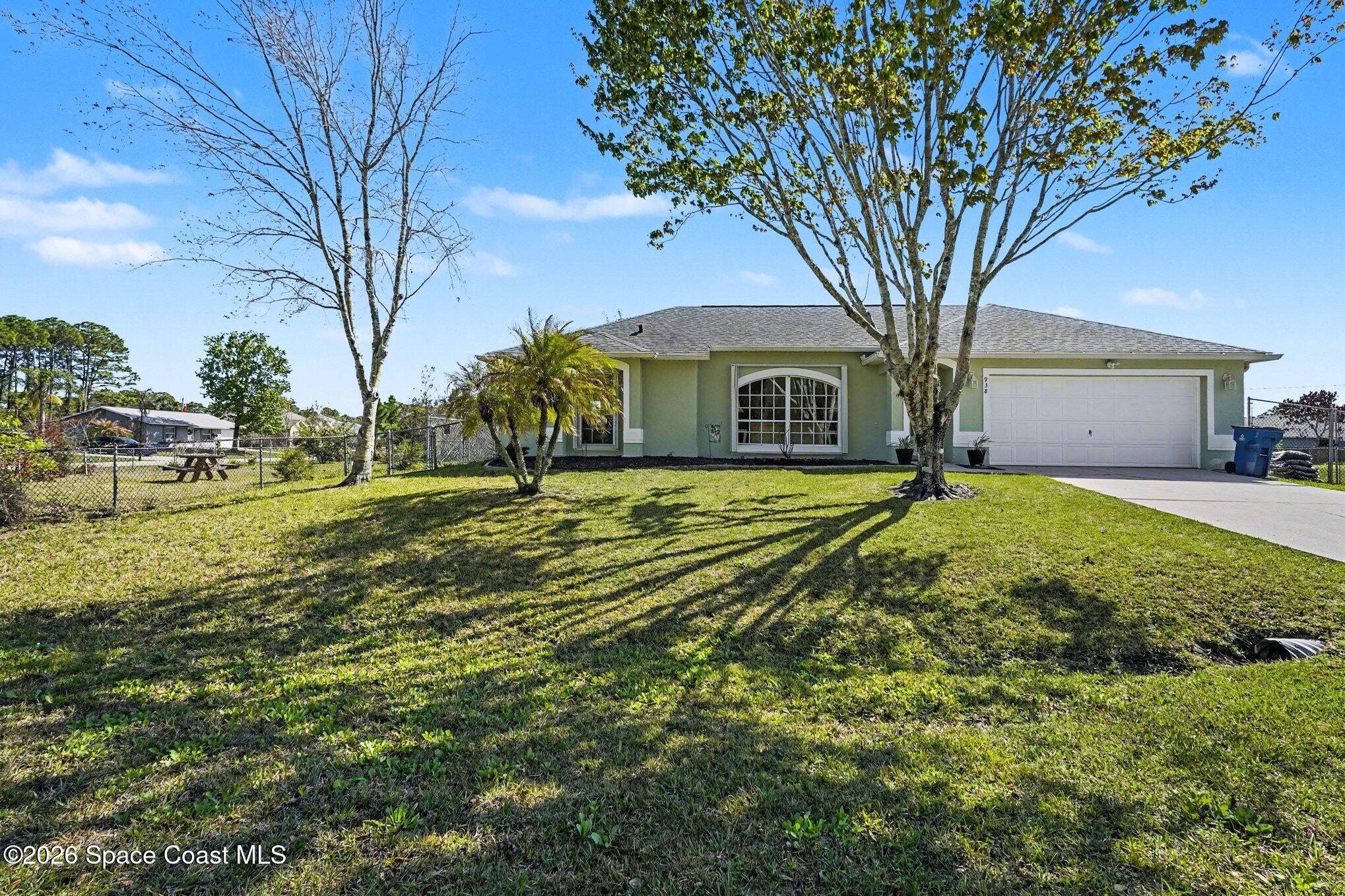 938 Commerce Road Southeast Palm Bay, FL 32909 - Photo 31 of 31 a view of a yard in front of the house