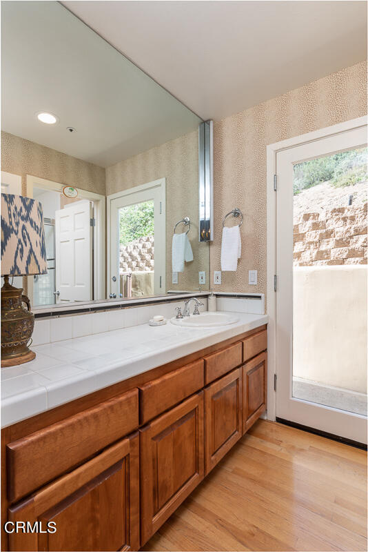1437 Rutherford Drive Pasadena, CA 91103 - Photo 19 of 44 a bathroom with a sink and a large mirror