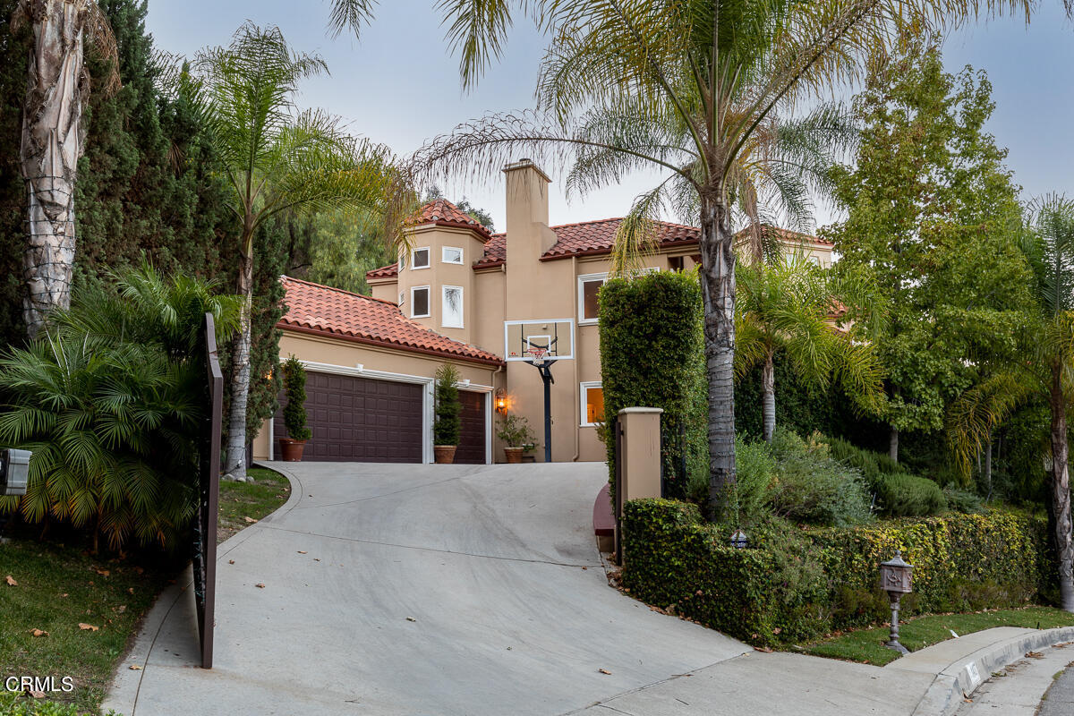 1437 Rutherford Drive Pasadena, CA 91103 - Photo 42 of 44 a front view of a house with a yard and garage