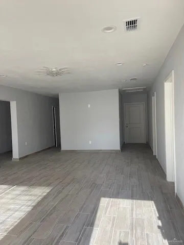a view of a room with wooden floor