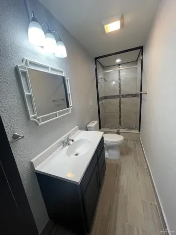a bathroom with a sink a large mirror and vanity