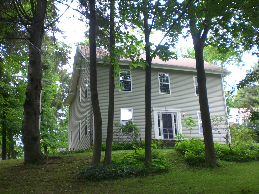 3 Oakham Road North Brookfield, MA 01535 - Photo 2 of 24 a view of a brick house with a large windows and a large tree