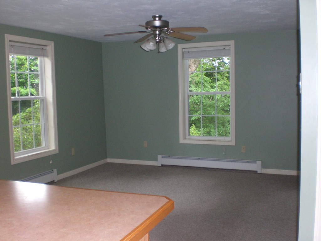 3 Oakham Road North Brookfield, MA 01535 - Photo 7 of 24 an empty room with windows and ceiling fan