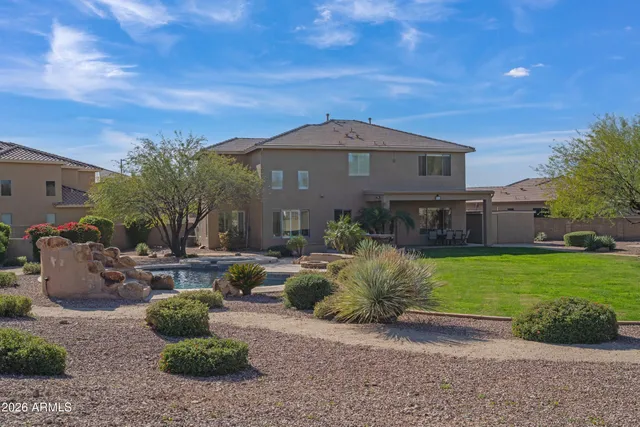 a living room with furniture kitchen view and a large window