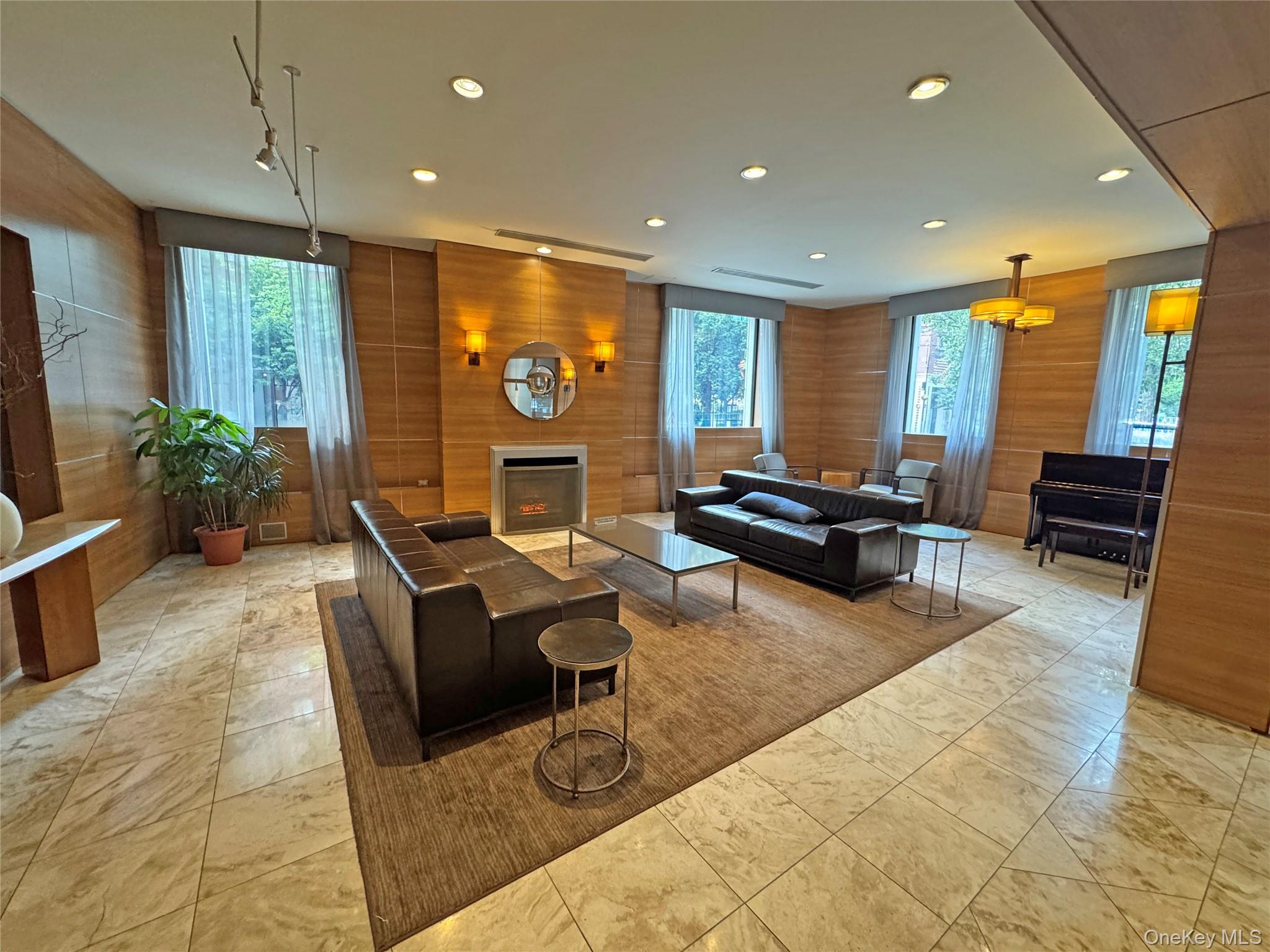 280 Rector Place, Unit 1G Manhattan, NY 10280 - Photo 12 of 17 a living room with furniture and a flat screen tv