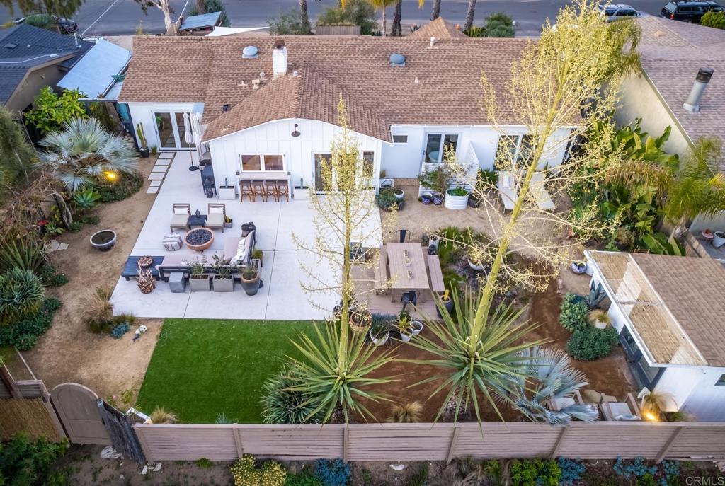 an aerial view of a house with a yard and seating area