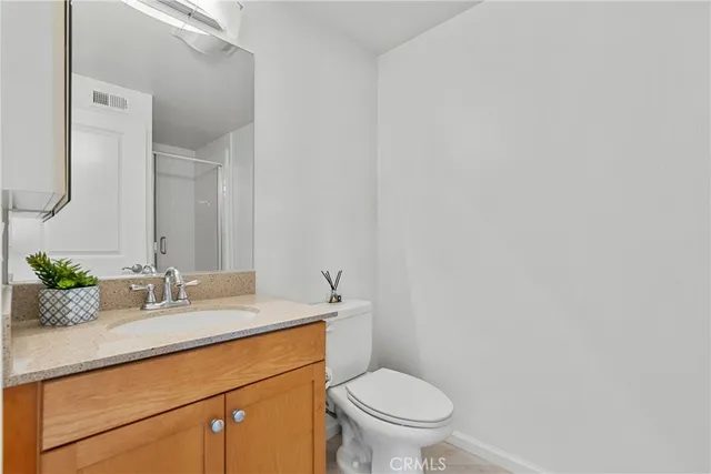 a view of a terrace with furniture and a floor to ceiling window