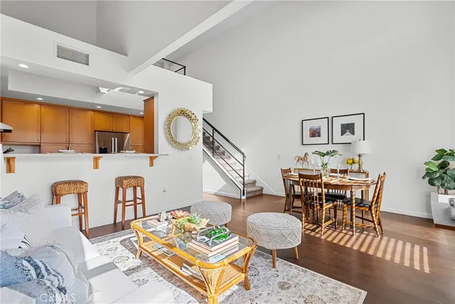 a kitchen with stainless steel appliances granite countertop a refrigerator a stove a sink and a microwave