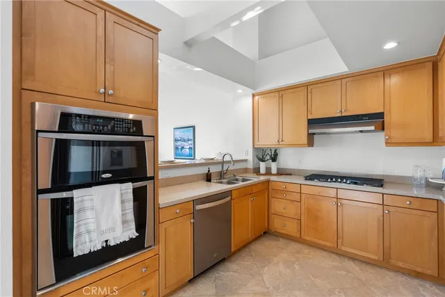 a kitchen with stainless steel appliances granite countertop a sink stove and cabinets