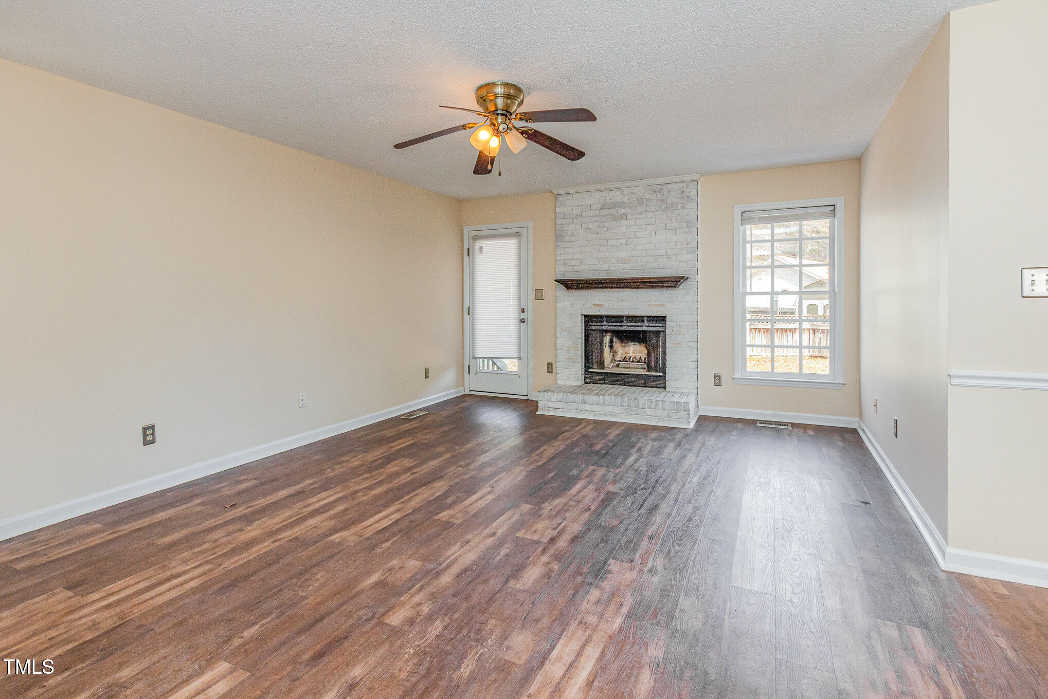 3332 Castlegate Drive Raleigh, NC 27616 - Photo 5 of 22 wooden floor in an empty room with a fireplace