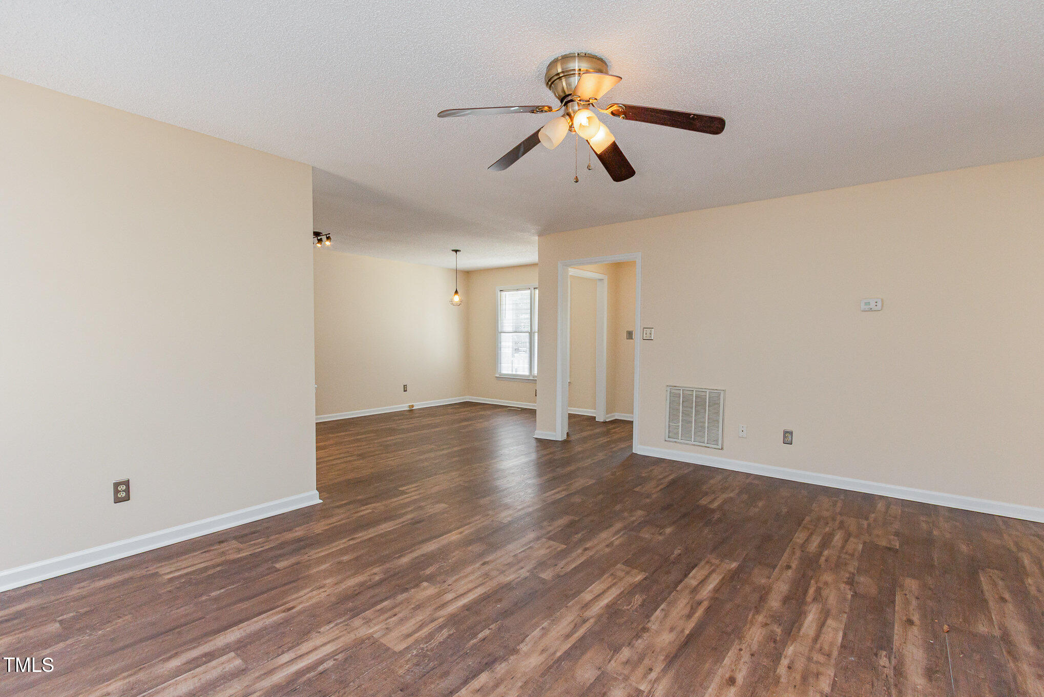 3332 Castlegate Drive Raleigh, NC 27616 - Photo 8 of 22 wooden floor in an empty room with a window