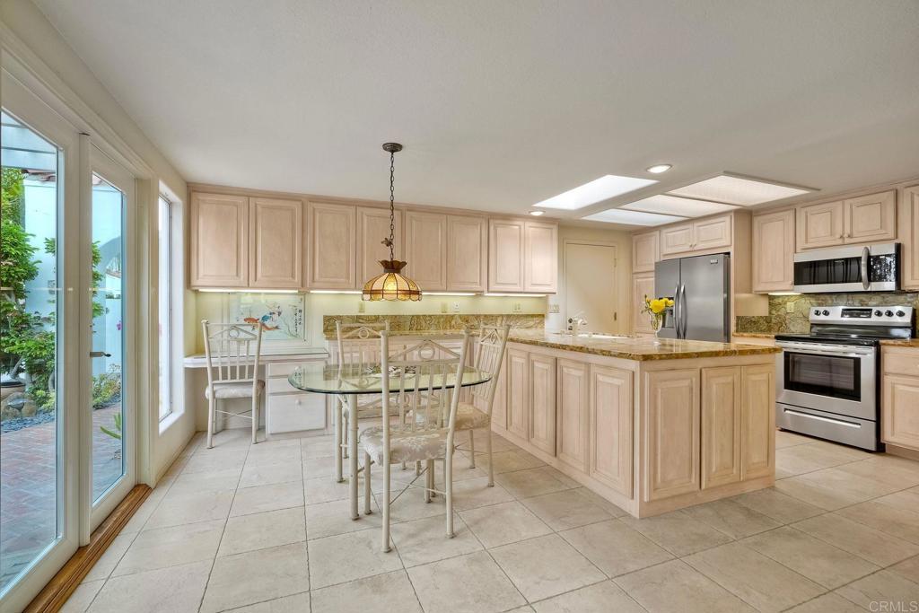 4760 Galicia Way Oceanside, CA 92056 - Photo 13 of 56 a kitchen with stainless steel appliances granite countertop a stove top oven a sink a counter space and cabinets
