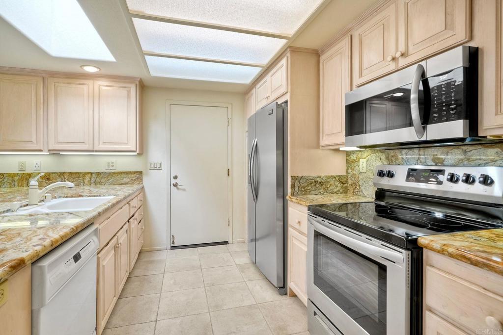 4760 Galicia Way Oceanside, CA 92056 - Photo 15 of 56 a kitchen with a stove and a microwave