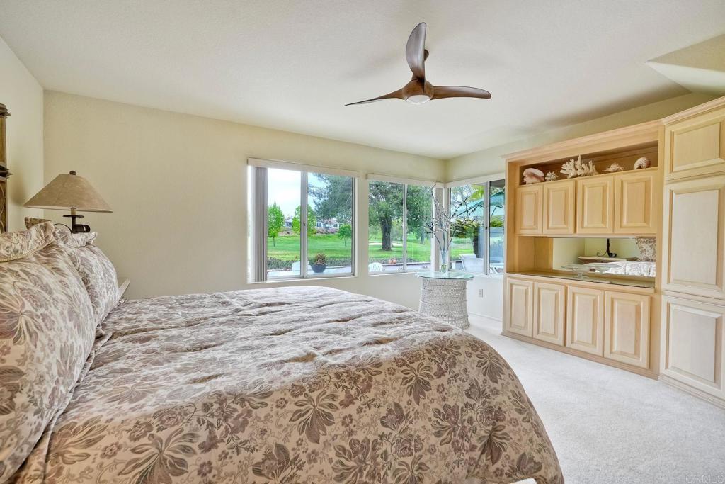 4760 Galicia Way Oceanside, CA 92056 - Photo 19 of 56 a bedroom with a large bed and a window