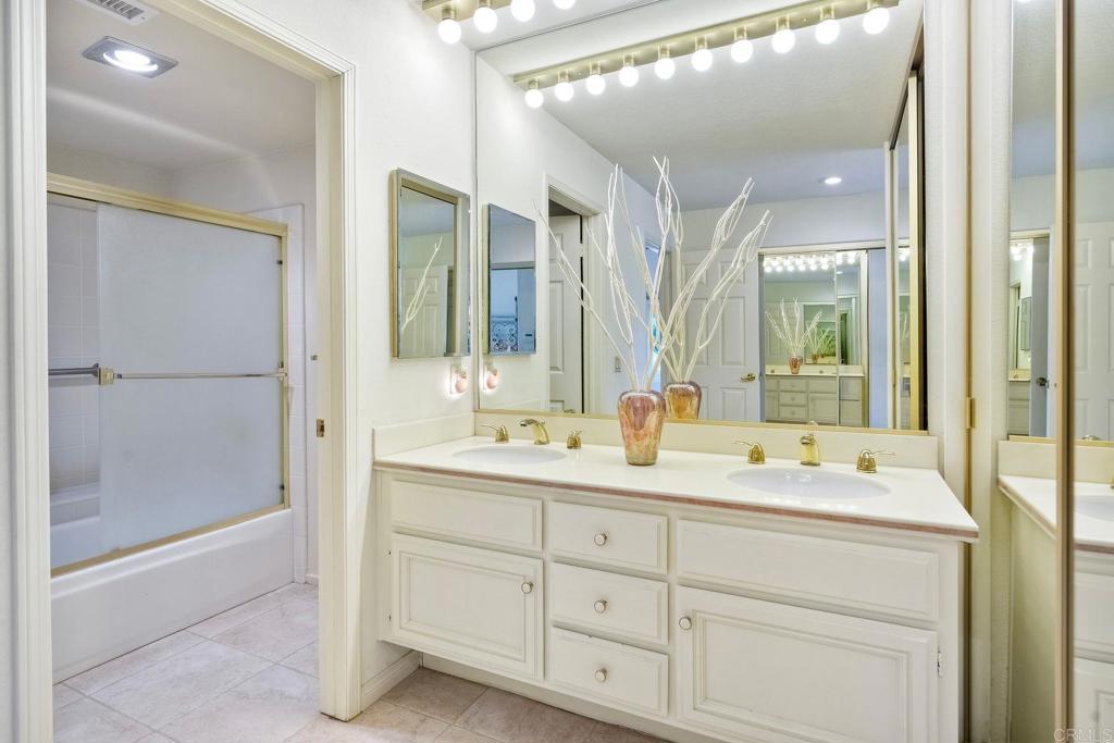 4760 Galicia Way Oceanside, CA 92056 - Photo 22 of 56 a bathroom with a double vanity sink mirror and double