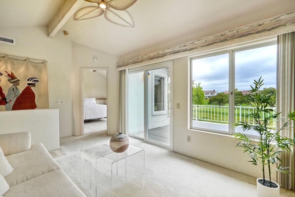 4760 Galicia Way Oceanside, CA 92056 - Photo 25 of 56 a living room with furniture and a floor to ceiling window