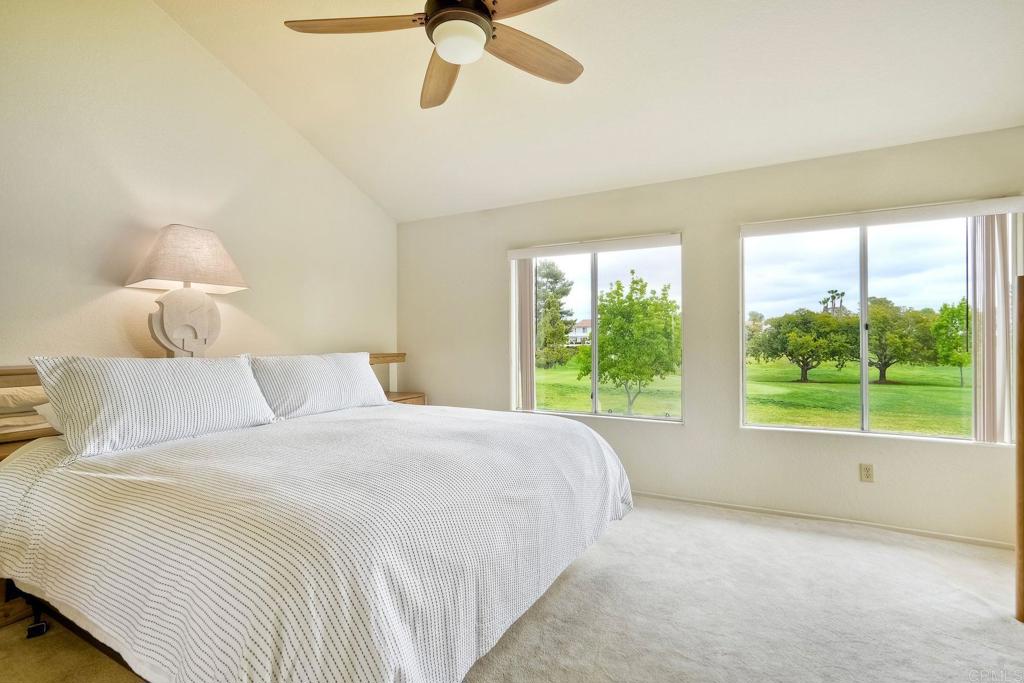 4760 Galicia Way Oceanside, CA 92056 - Photo 27 of 56 a bedroom with a bed and a large window