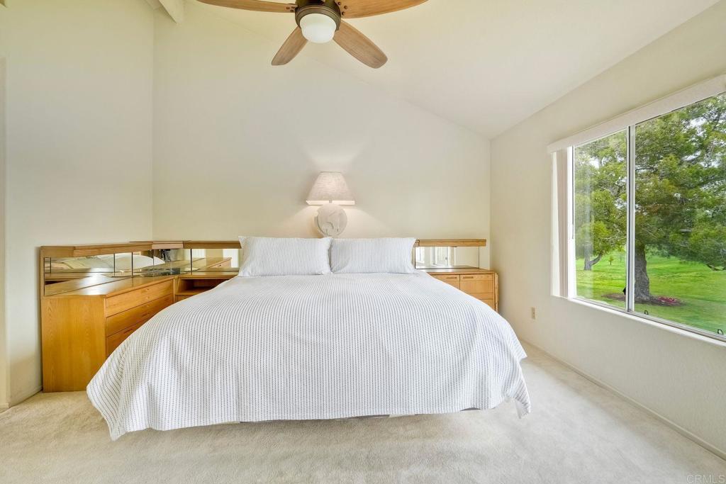 4760 Galicia Way Oceanside, CA 92056 - Photo 28 of 56 a bedroom with a bed and window