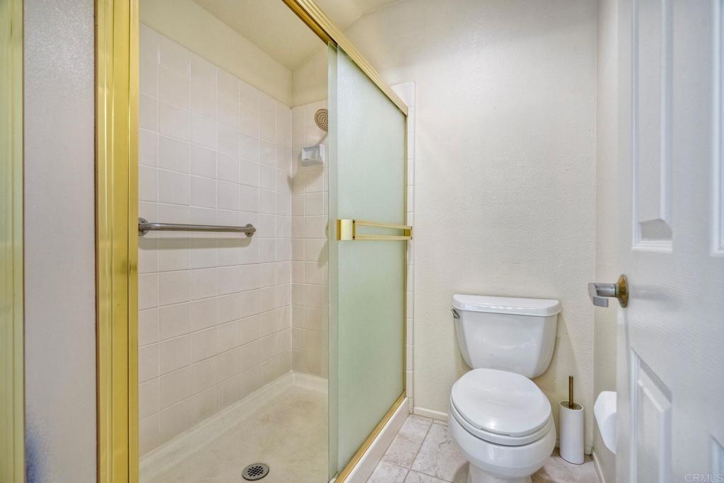 4760 Galicia Way Oceanside, CA 92056 - Photo 31 of 56 a white toilet sitting next to a bathroom sink