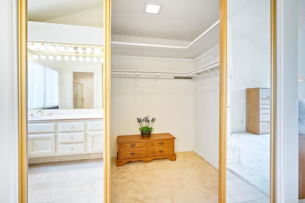 4760 Galicia Way Oceanside, CA 92056 - Photo 33 of 56 a bathroom with a tub sink and mirror