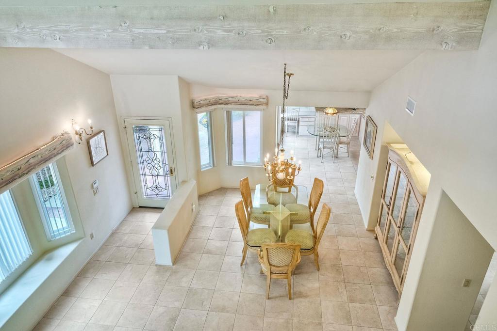 4760 Galicia Way Oceanside, CA 92056 - Photo 34 of 56 a dining room with furniture and a chandelier