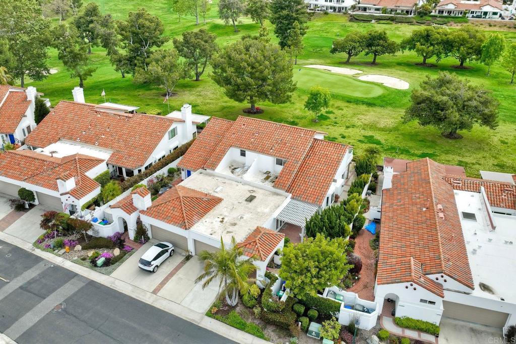 4760 Galicia Way Oceanside, CA 92056 - Photo 37 of 56 an aerial view of a house with garden space and street view