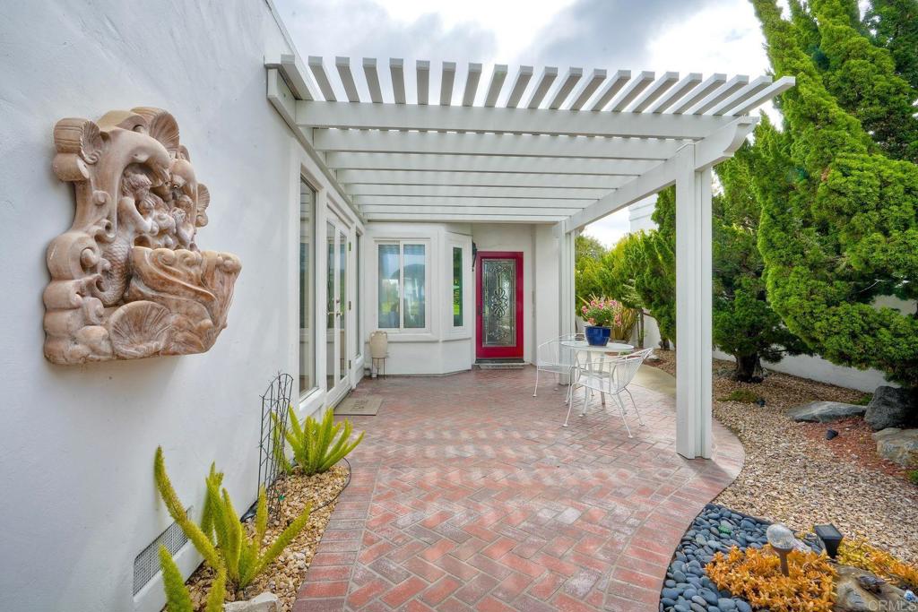 4760 Galicia Way Oceanside, CA 92056 - Photo 4 of 56 a porch with a table and chairs in patio