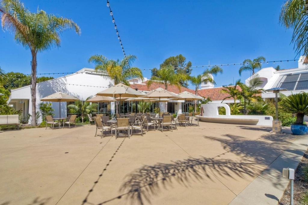 4760 Galicia Way Oceanside, CA 92056 - Photo 49 of 56 a view of a patio with a table and chairs under an umbrella