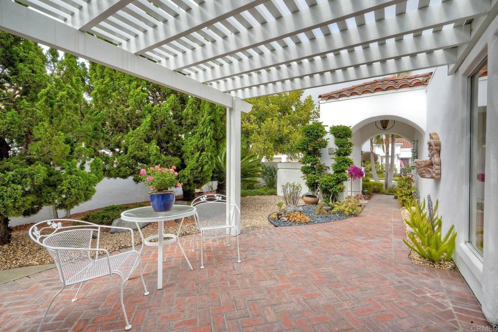 4760 Galicia Way Oceanside, CA 92056 - Photo 5 of 56 a patio with a table and chairs and potted plants