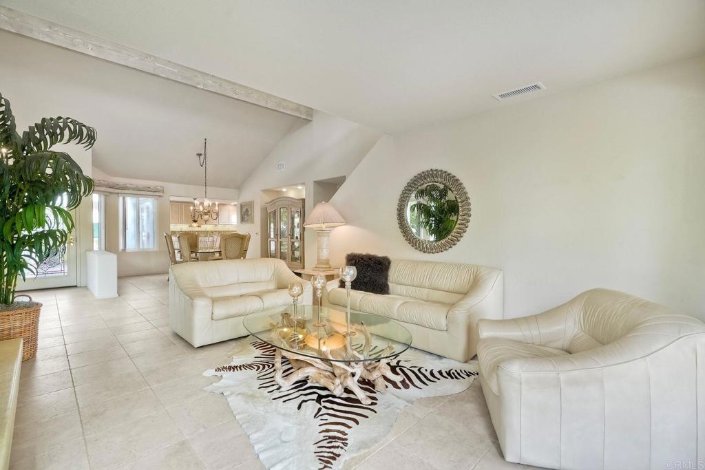 4760 Galicia Way Oceanside, CA 92056 - Photo 10 of 56 a living room with furniture a clock and a potted plant