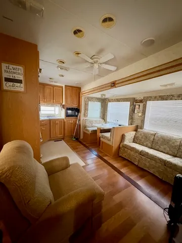 a living room with furniture and kitchen view