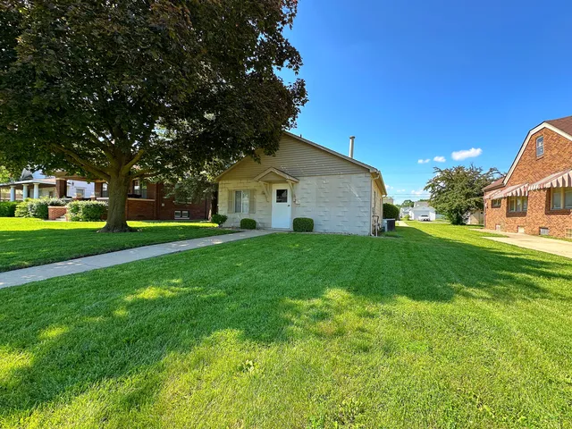 a front view of house with yard and green space