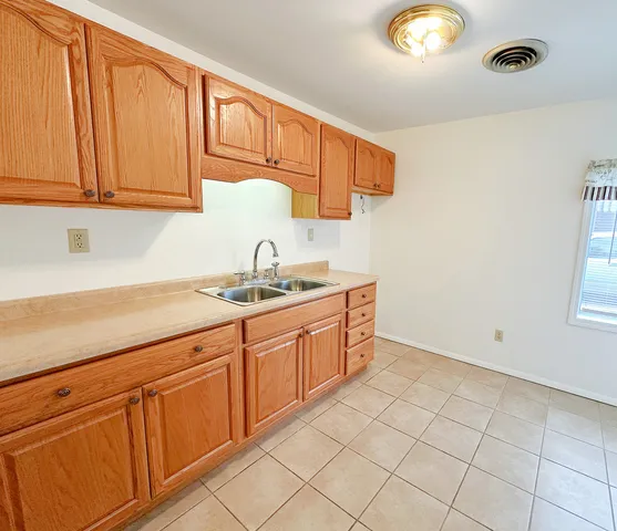 a kitchen with sink cabinets and utility