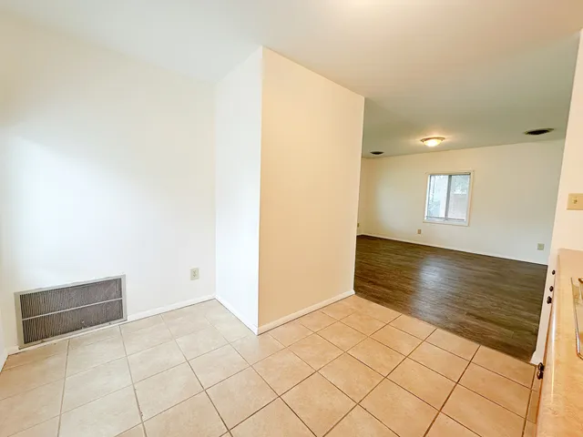 a view of an empty room and wooden floor