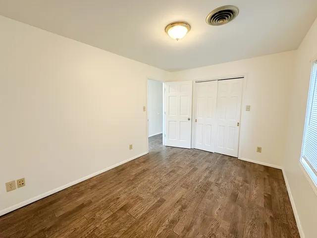 an empty room with wooden floor