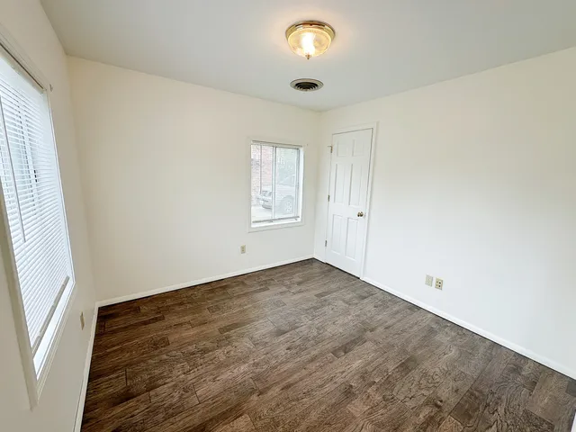 an empty room with windows and entrance