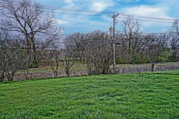 a view of a backyard with large trees