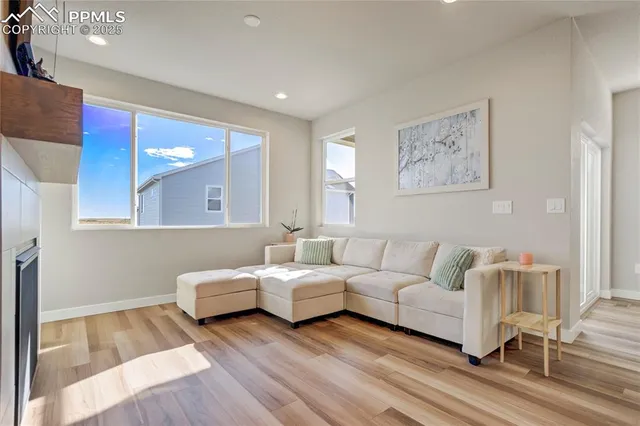 a living room with furniture and a wooden floor