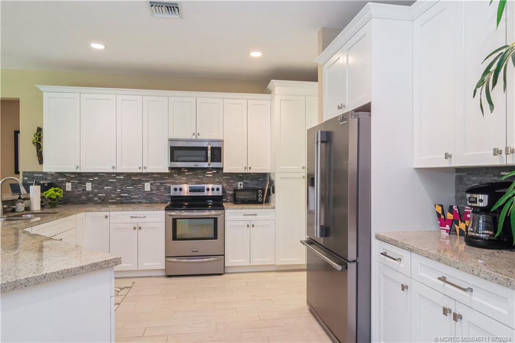299 Southwest Cocoloba Way Stuart, FL 34997 - Photo 13 of 35 Shaker-style wood cabinets