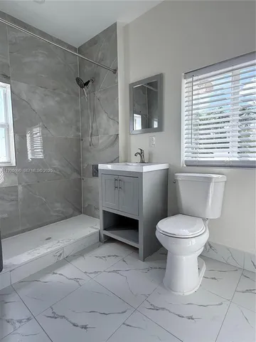 a bathroom with a toilet sink and shower