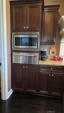 a kitchen with granite countertop stainless steel appliances and wooden cabinets