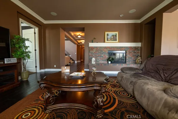 a living room with patio furniture and a fireplace