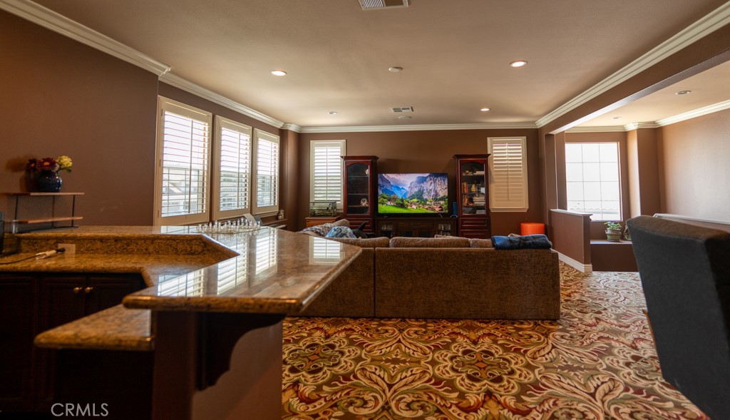 5075 Branding Iron Place Rancho Cucamonga, CA 91739 - Photo 15 of 41 a living room with furniture and a flat screen tv