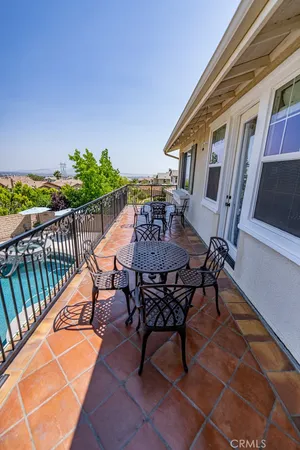 a view of a patio with a table and chairs