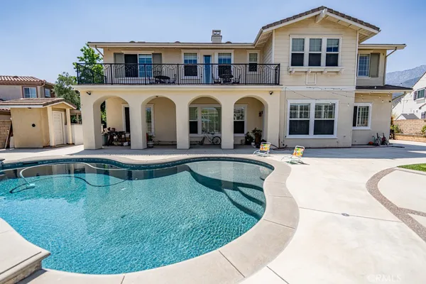 a view of a house with swimming pool and porch