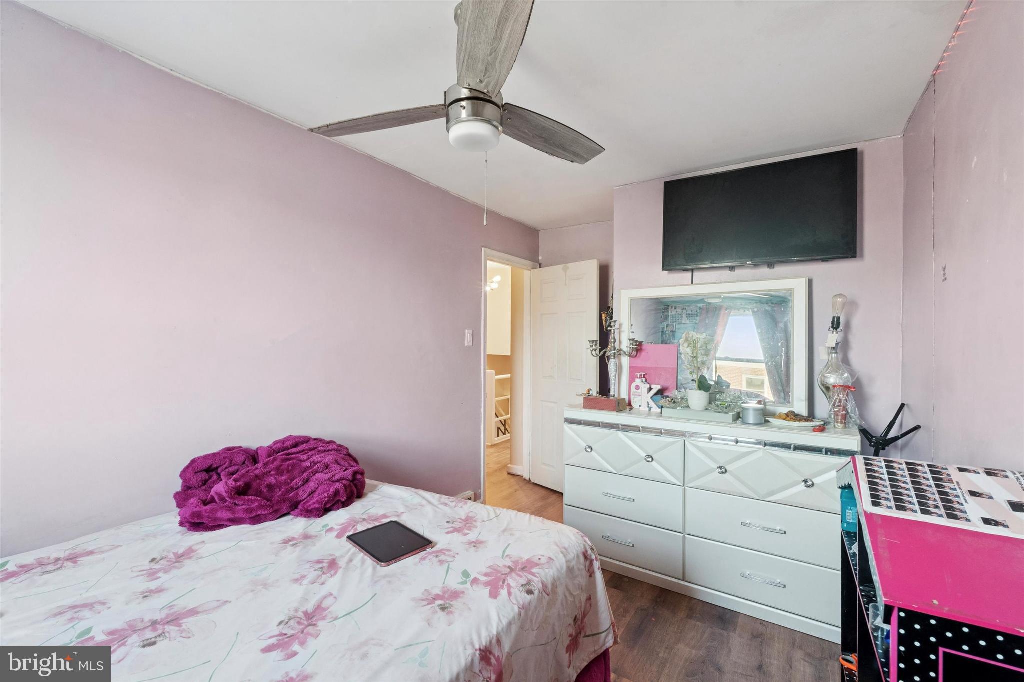 213 East Claremont Road Philadelphia, PA 19120 - Photo 12 of 25 a bedroom with a bed a flat screen tv and a dresser