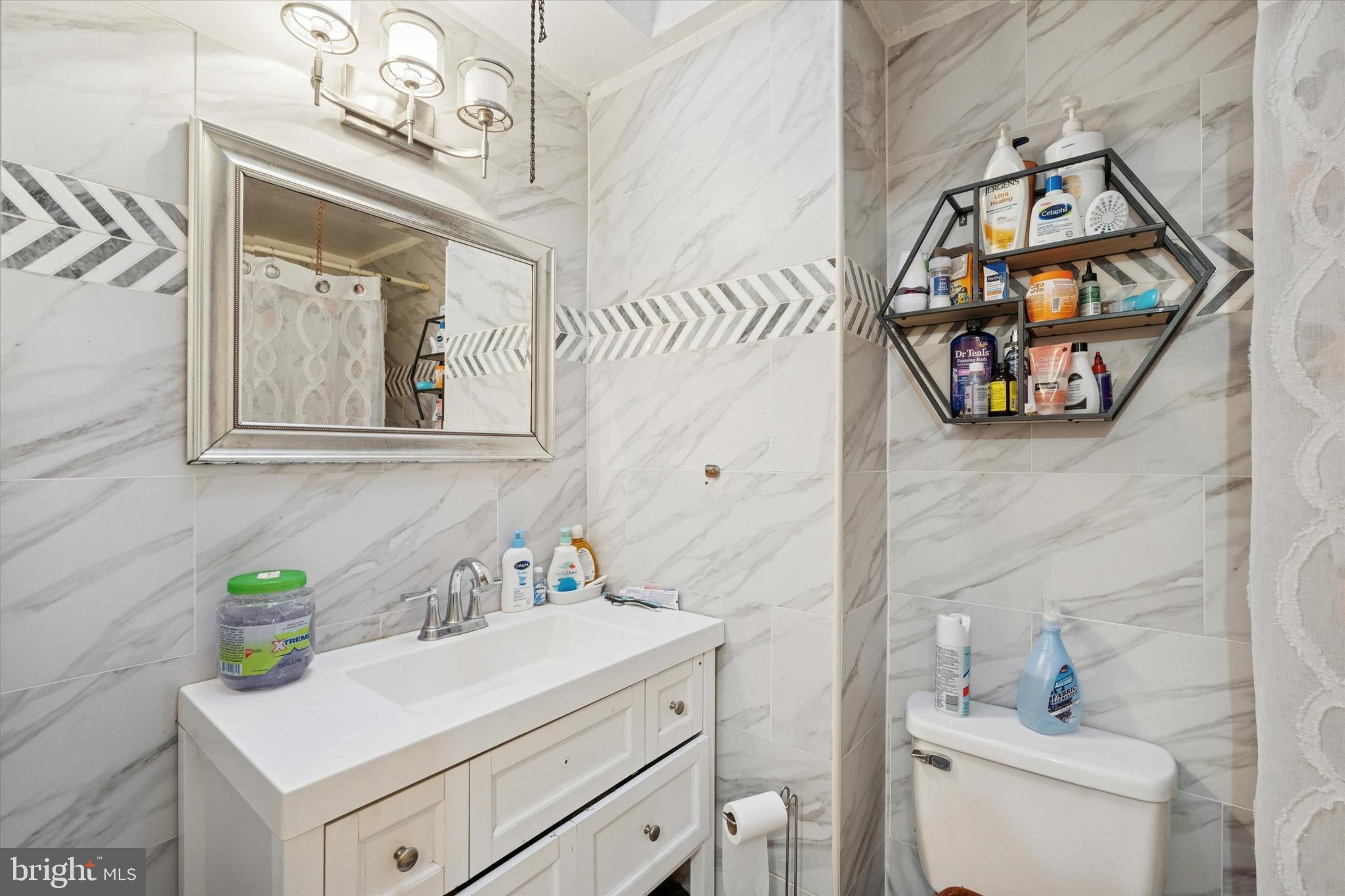 213 East Claremont Road Philadelphia, PA 19120 - Photo 13 of 25 a bathroom with a sink vanity and mirror