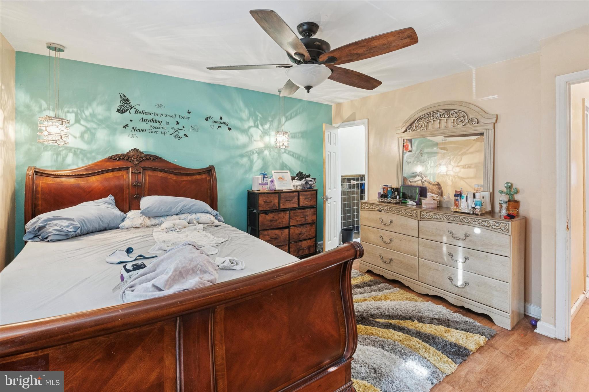 213 East Claremont Road Philadelphia, PA 19120 - Photo 15 of 25 a bedroom with a bed a mirror on dresser and a large mirror